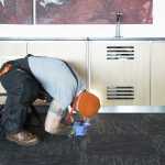 Checking for pests under the worktops on site at MTC